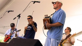 Horace Trahan and Matt Doucet, backed by the Bluerunners, play to the crowd at the Festival International de Louisiane in Lafayette