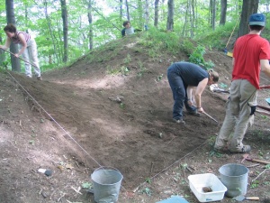 Archaeologists studying an embrasure at Fort Jacques-Cartier