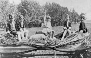 Children sitting in a wagon during celebrations of the feast day of St. John the Baptist in Notre Dame de Lourdes.