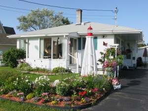 Scale model of the Pointe-au-Père Lighthouse in the front yard of a private home.