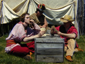 Groupe de comédiens incarnant des voyageurs en train de jouer aux cartes, fort William